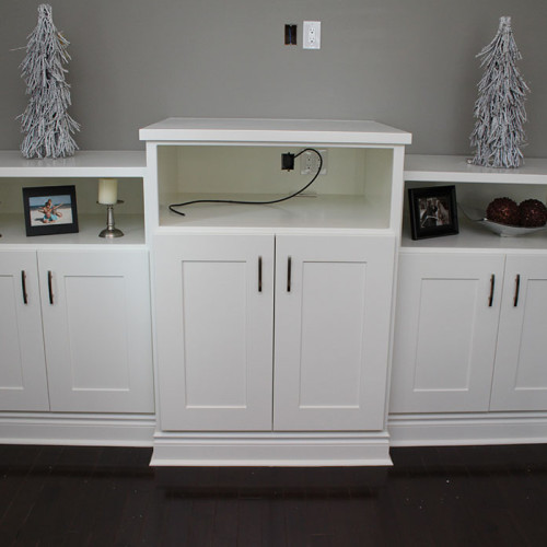 This custom entertainment unit features two shelving units and one drawer unit.